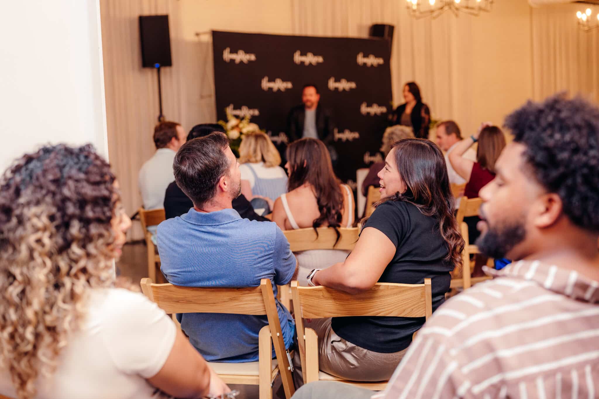 HoneyRock FOCUS Marriage Event couples discussing content from the speakers. Stage featuring Joshua and Rachael Wintermute from Quiet Winters, LLC - Design + Life Coaching.
